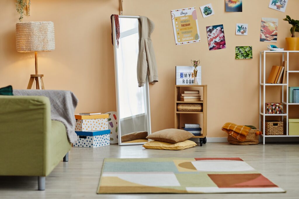 Part of spacious living room or room of schoolchild with variety of stuff